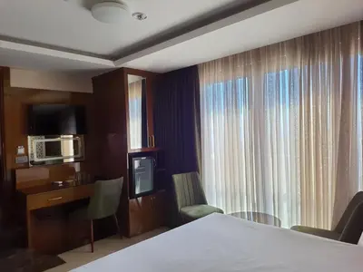 a hotel room with a bed and a desk and a microwave at Grand Star Hotel Premium in Istanbul