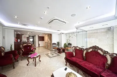 a living room with red couches and a table at Istanbul Newcity Hotel in Istanbul