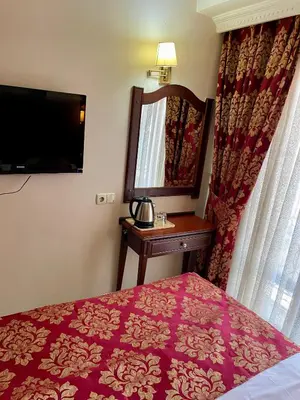 a hotel room with a bed and a mirror at Istanbul Newcity Hotel in Istanbul
