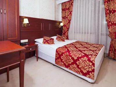 a hotel room with a bed and a desk at Istanbul Newcity Hotel in Istanbul