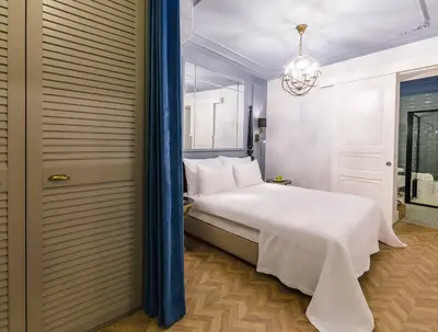 a bedroom with a white bed and a chandelier at The Soul Istanbul Hotel in Istanbul