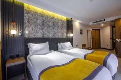 a hotel room with two beds in a room at Kayhan City Hotel in Bursa
