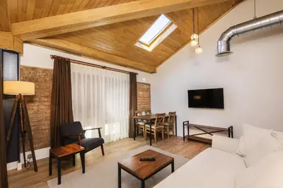 a living room with a couch and a table at The Nomad Inn Old City İstanbul in Istanbul