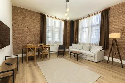 a living room with a white couch and a table at The Nomad Inn Old City İstanbul in Istanbul