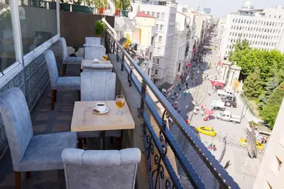 a table and chairs on a balcony with a view of a city at Golden Street Hotel in Istanbul