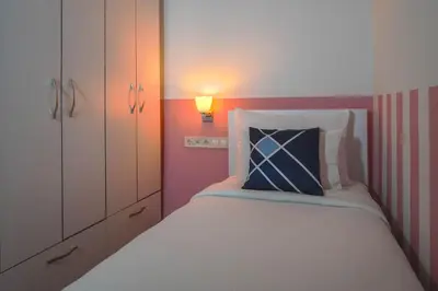 a bedroom with a bed with a blue pillow on it at Four Points Flex by Sheraton Bursa Nilüfer in Bursa