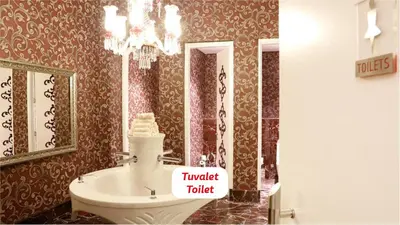 a bathroom with a toilet and a sink at Yalova Lova Hotel & SPA Yalova in Yalova