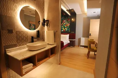 a bathroom with a sink and a bed in a room at My Garden Hotel in Istanbul