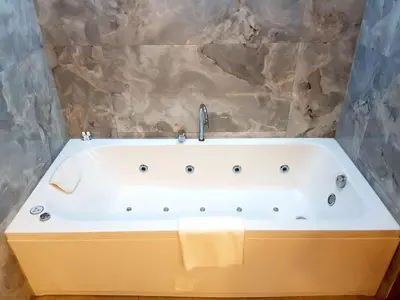 a bath tub with a sink in a bathroom at My Garden Hotel in Istanbul