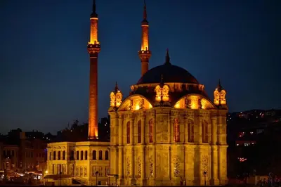 a large building with two towers at night at İmmortal Hotel İstanbul in Istanbul