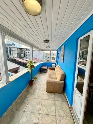 a living room with blue walls and a couch at İmmortal Hotel İstanbul in Istanbul