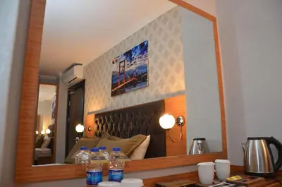 a mirror on a wall in a room at Otel Grand Lark İstanbul in Istanbul