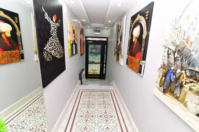 a hallway with paintings on the walls at Little sofia hotel in Istanbul