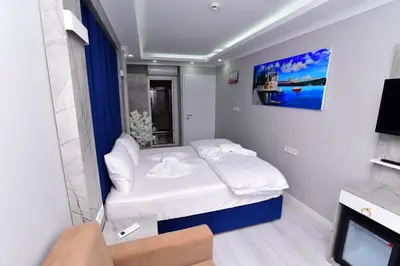 a small room with a bed and a tv at Little sofia hotel in Istanbul
