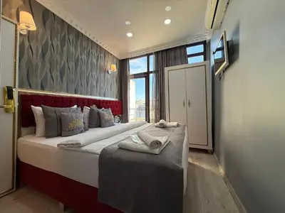 a bedroom with a large bed and a large window at RHYTHM HOTEL in Istanbul
