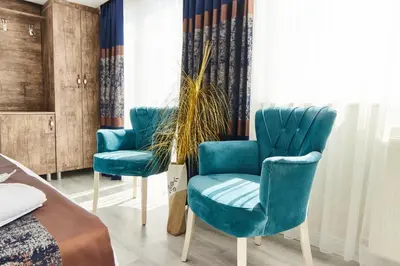 a room with two blue chairs in front of a window at Armar Hotel in Istanbul