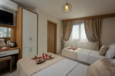 a hotel room with two beds and a tv at Zeyn Otel Istanbul in Istanbul