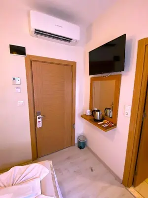 a room with a door and a television on the wall at Zeyn Otel Istanbul in Istanbul