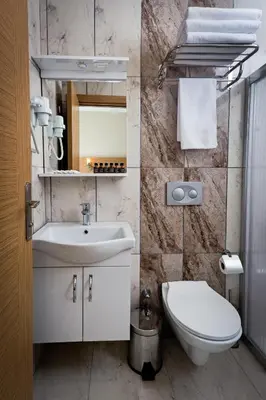 a bathroom with a white sink and a toilet at Zeyn Otel Istanbul in Istanbul
