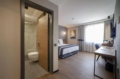 a bathroom with a bed and a toilet in a room at GRANBELLAHOTEL in Tekirdag