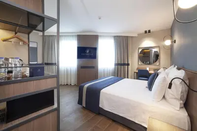a hotel room with a bed and a mirror at GRANBELLAHOTEL in Tekirdag