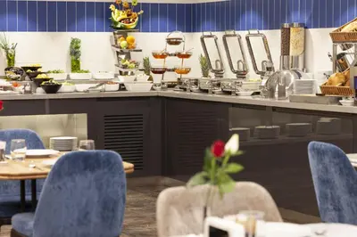 a kitchen with a table and chairs in a restaurant at GRANBELLAHOTEL in Tekirdag