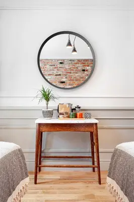 a mirror on a wall next to a table at World House Boutique Hotel Galata in Istanbul