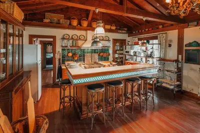a kitchen with a large island with bar stools at The Lake House in Boyalıca
