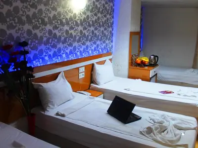 a room with two beds with a laptop on it at Avcılar İnci Hotel in Istanbul
