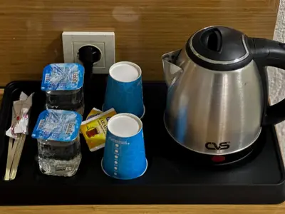 a tea kettle and two cups on a tray at Avcılar İnci Hotel in Istanbul