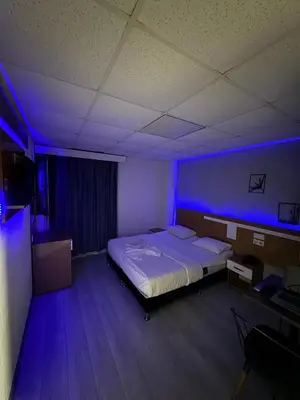 a bedroom with a bed with a blue light at Avcılar İnci Hotel in Istanbul