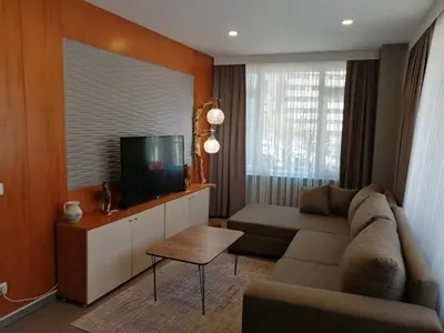 a living room with a couch and a flat screen tv at Levent Apartments in Istanbul