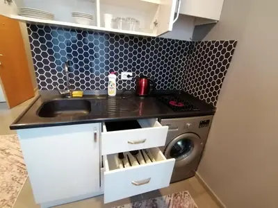 a kitchen with a sink and a washing machine at Levent Apartments in Istanbul