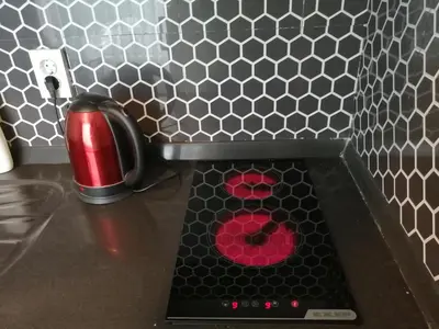 a stove top with a red substance in the middle at Levent Apartments in Istanbul
