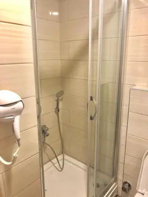 a shower with a glass door in a bathroom at NOUR SUITE & RESIDENCE in Istanbul
