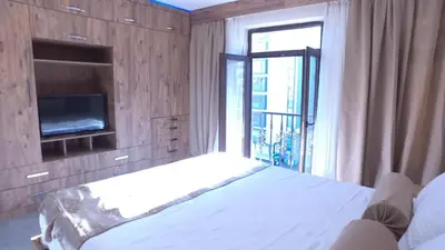 a bedroom with a white bed and a tv at NOUR SUITE & RESIDENCE in Istanbul