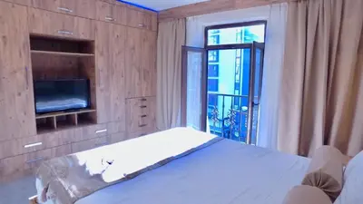 a bedroom with a bed and a tv and a window at NOUR SUITE & RESIDENCE in Istanbul