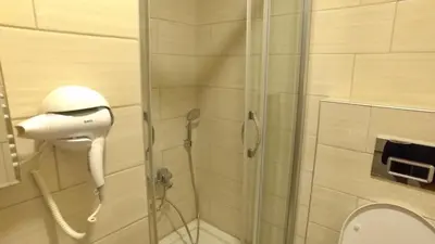 a shower stall with a blow dryer in a bathroom at NOUR SUITE & RESIDENCE in Istanbul