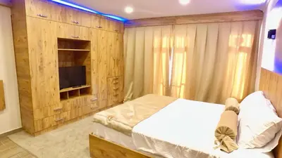 a bedroom with a large bed and a television at NOUR SUITE & RESIDENCE in Istanbul