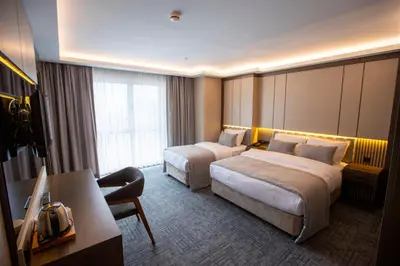 a hotel room with two beds and a desk at THE GREEN HOTEL in Istanbul