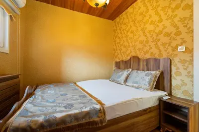 a small bedroom with a bed and a yellow wall at Kervanchi in Istanbul
