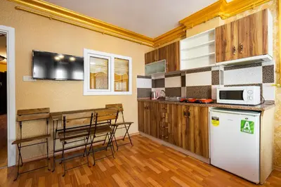 a kitchen with a refrigerator and a table with chairs at Kervanchi in Istanbul