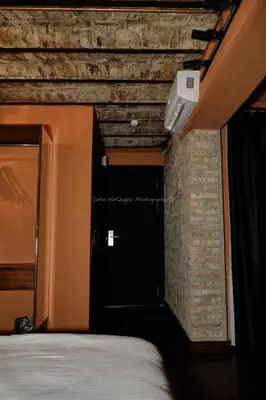 a bedroom with a door and a brick wall at Reu de Hotel in Istanbul