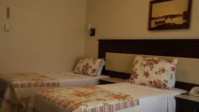 a hotel room with two beds and a telephone at Kumburgaz Blue World Hotel in Buyukcekmece