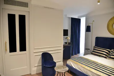 a bedroom with a bed and a blue chair at A11 HOTEL Exclusive in Istanbul