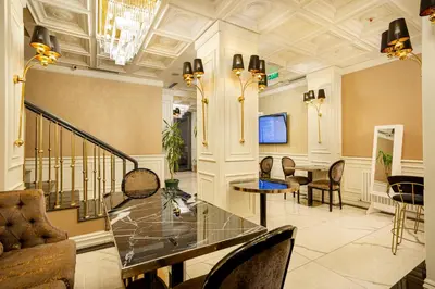 a lobby with a glass table and chairs at Santra Hotel in Istanbul
