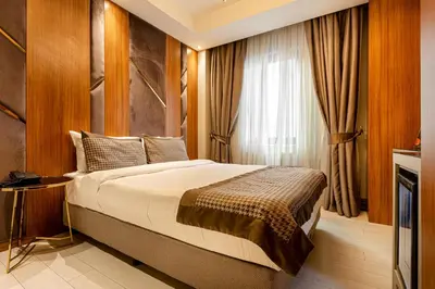 a bedroom with a large bed and a window at Santra Hotel in Istanbul