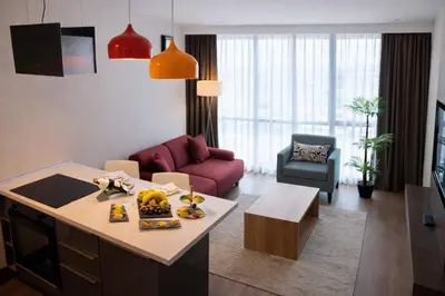 a kitchen and living room with a table and a couch at Prime Istanbul Residences in Istanbul