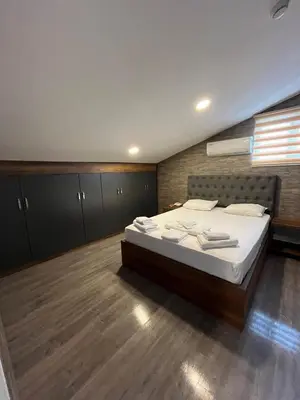 a bedroom with a large bed with towels on it at La Vie Suite Hotel in Istanbul
