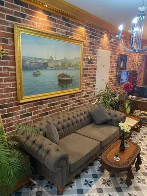 a living room with a couch against a brick wall at Bosphorus Bridge in Istanbul